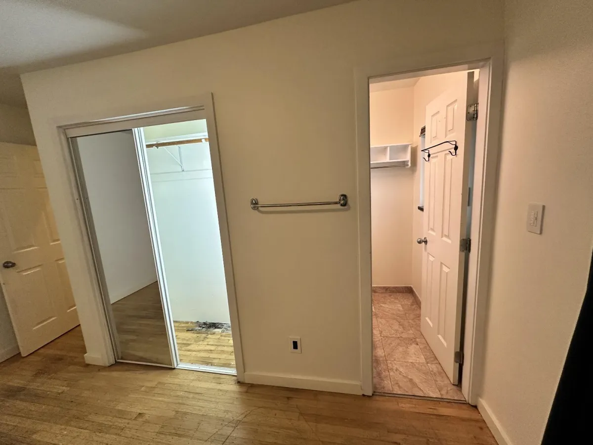 Burnaby ensuite area before renovation showing old bathroom entry and dated finishes