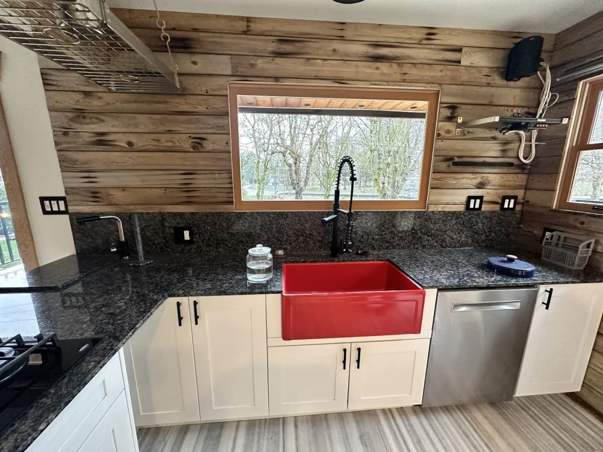 Kitchen before renovation with rustic wood plank walls