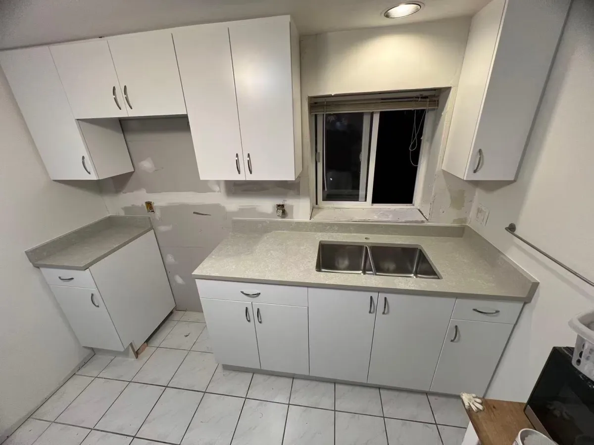 Kitchen renovation in progress with new cabinets and countertops installed